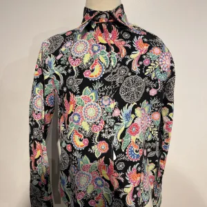 Black shirt w/ a bright floral pattern